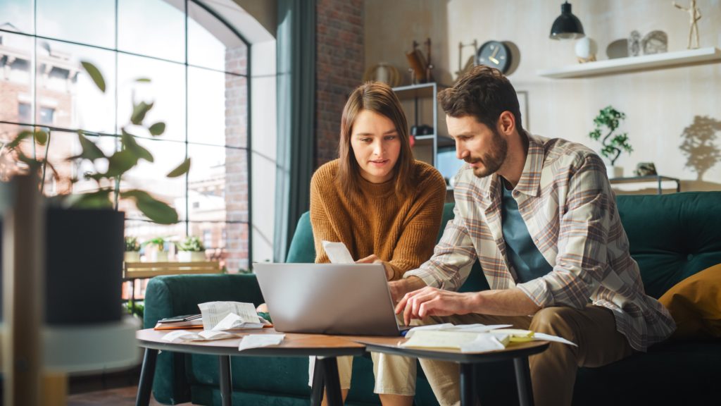 Man and woman looking at laptop while accounting